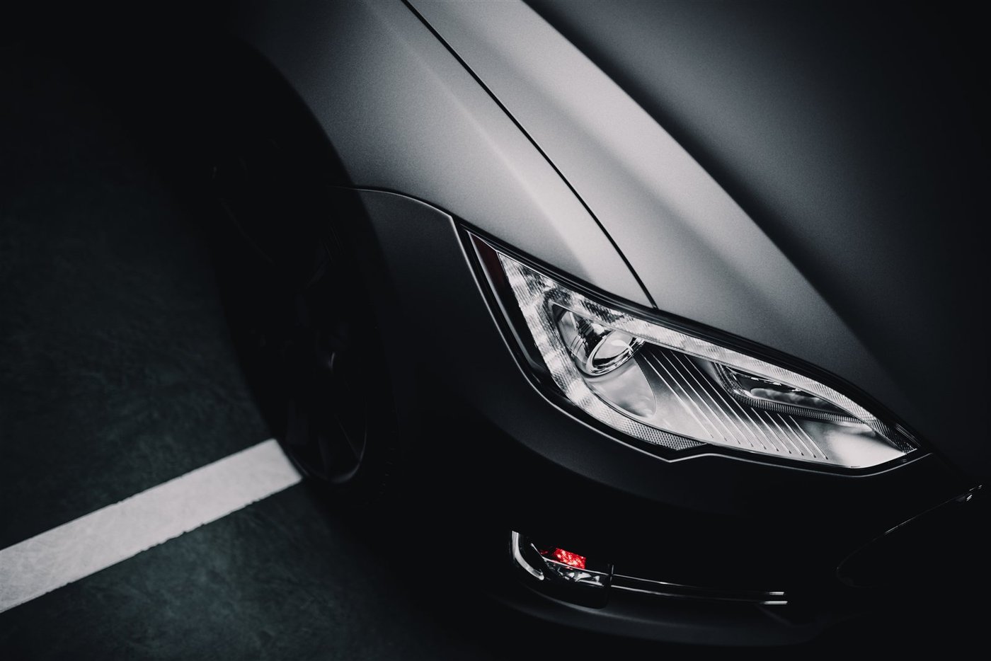 Tesla with a satin gray color change wrap, headlight close-up