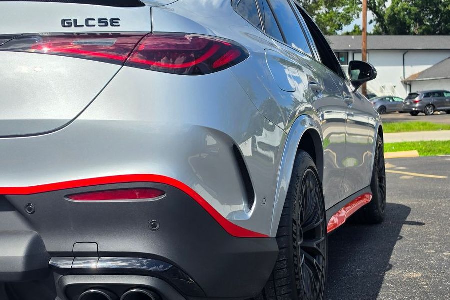 Rear of a silver Mercedes-AMG GLC 53 with red accent trim along the bumper and side skirt