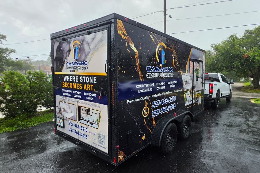 Rear three-quarter view of the granite company trailer with full-colour printed graphics
