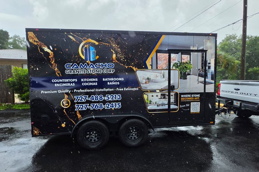Enclosed trailer with a black and gold marble wrap for Camacho Granite Stone Corp
