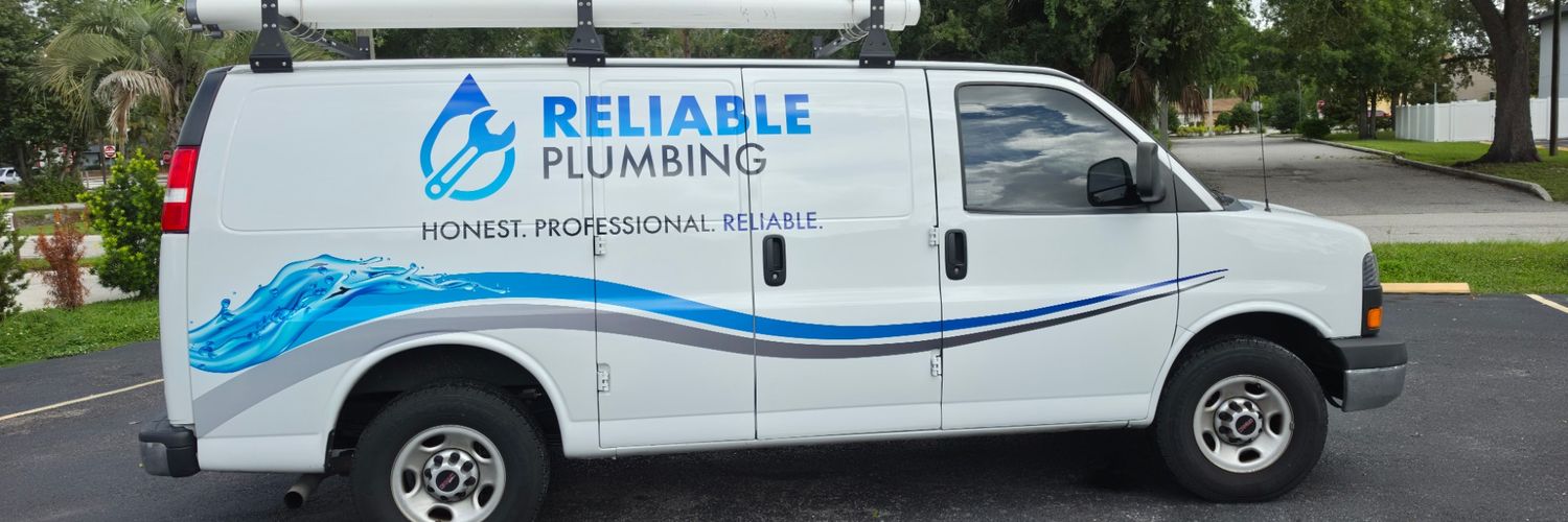GMC Savana van with a blue water-wave wrap for Reliable Plumbing